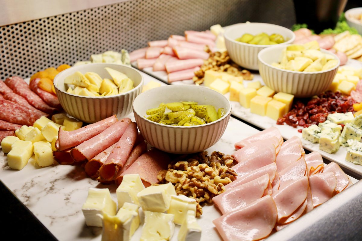 Charcuterie board inspired buffet at Twin City hotel featuring cured meats, cheeses, crackers, fresh fruit and antipasto meals.